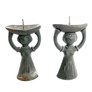 A pair of antique “Corn Women” bronze sculptural candlestick holders.